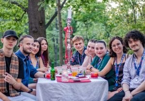 Stundets sitting at a table during a barbecue